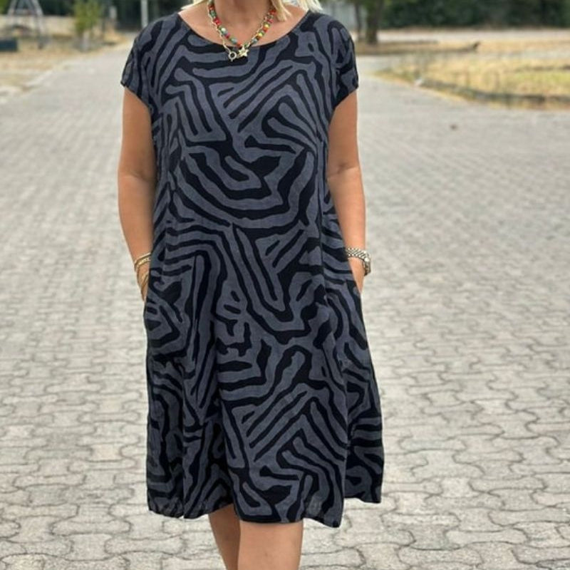 "Alie™ - Summer Dress with Round Neckline" could be rewritten as "Alie™ - Round Neck Summer Dress for the Perfect Look".