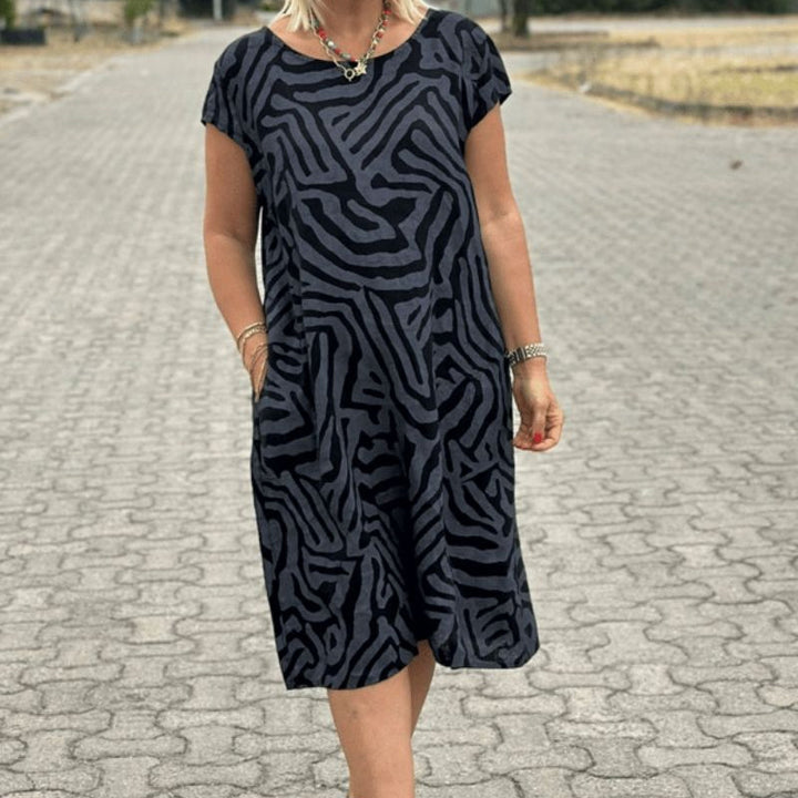 "Alie™ - Summer Dress with Round Neckline" could be rewritten as "Alie™ - Round Neck Summer Dress for the Perfect Look".