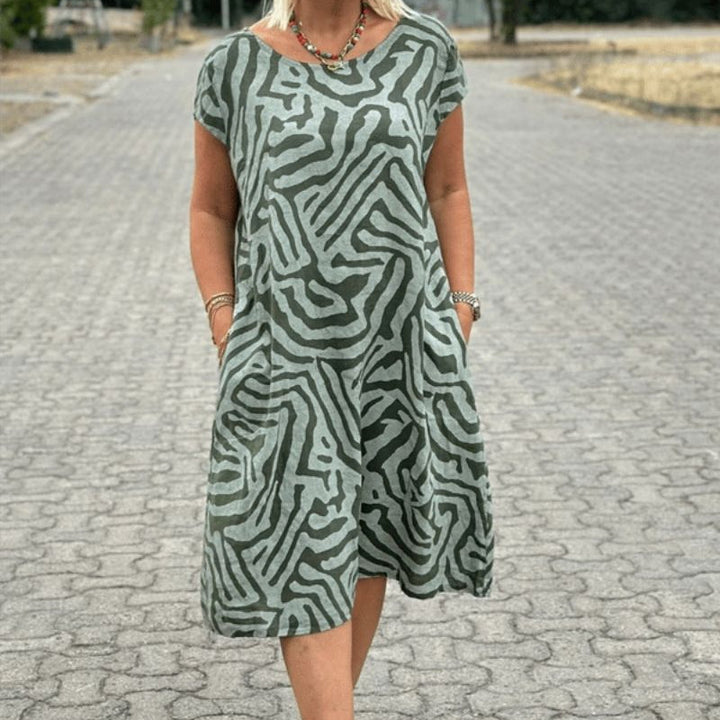 "Alie™ - Summer Dress with Round Neckline" could be rewritten as "Alie™ - Round Neck Summer Dress for the Perfect Look".