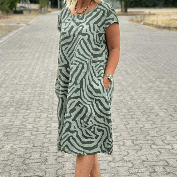 "Alie™ - Summer Dress with Round Neckline" could be rewritten as "Alie™ - Round Neck Summer Dress for the Perfect Look".